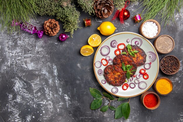 Top view yummy cutlets with onion rings on the grey background dish meat meal photo