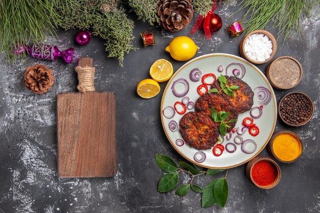 Top view yummy cutlets with onion rings on grey desk dish meat meal photo