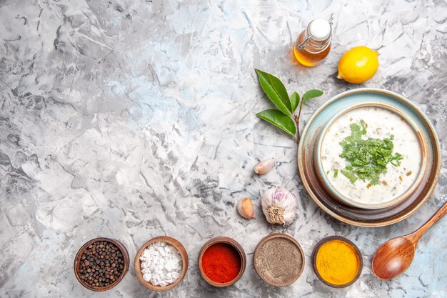 Top view yummy dovga yogurt soup with seasonings on white dish milk soup