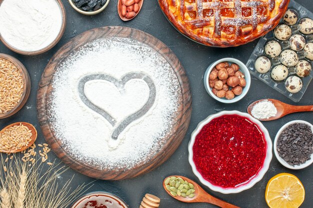 Top view yummy fruity pie with flour jam and nuts on the dark fruit sweet pie sugar tea pastry dessert biscuit cake