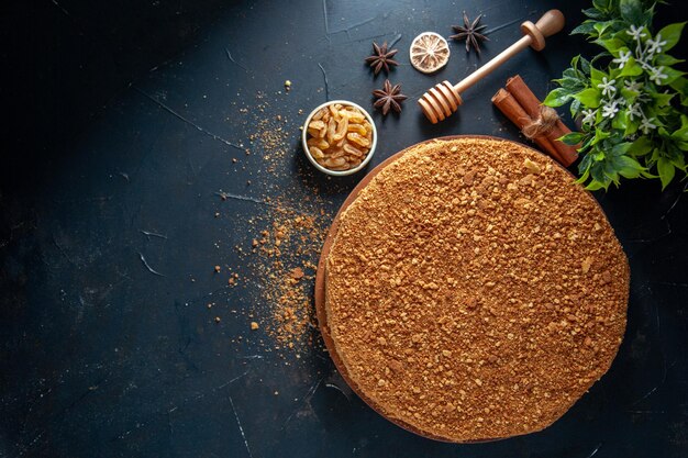 Top view yummy honey cake on dark surface