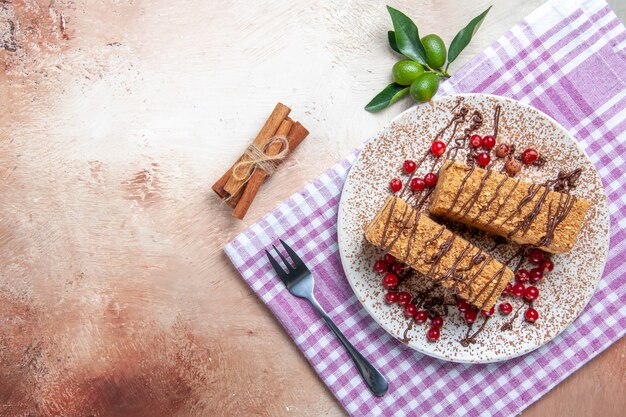 Top view yummy honey cake with red berries on light