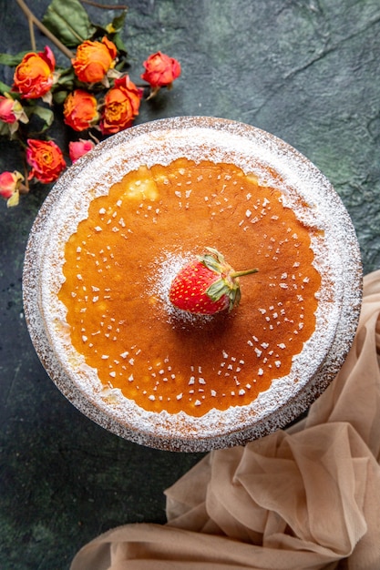 Top view yummy honey cake with sugar powder on round wooden board dark surface