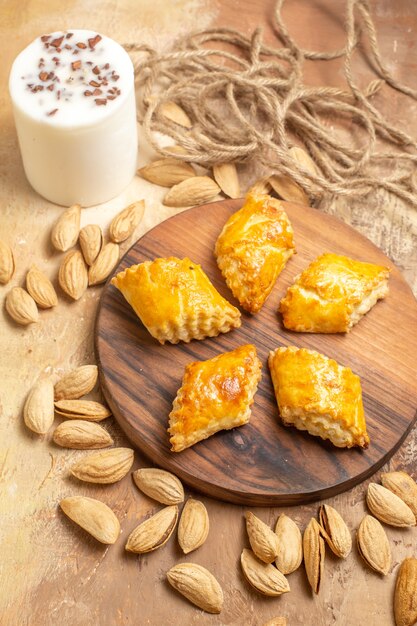 Top view yummy nut pastries with nuts on wooden floor