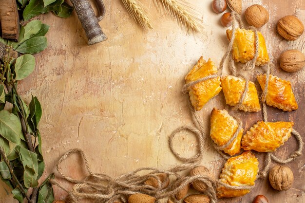 Top view of yummy nut pastries with ropes and nuts