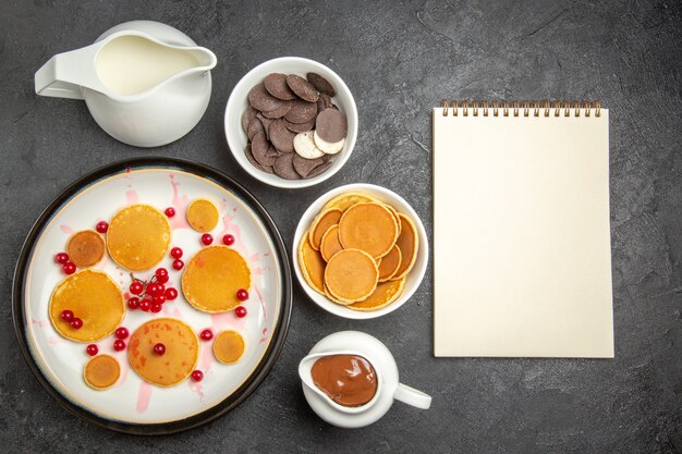 Top view yummy pancakes with cookies on the grey background