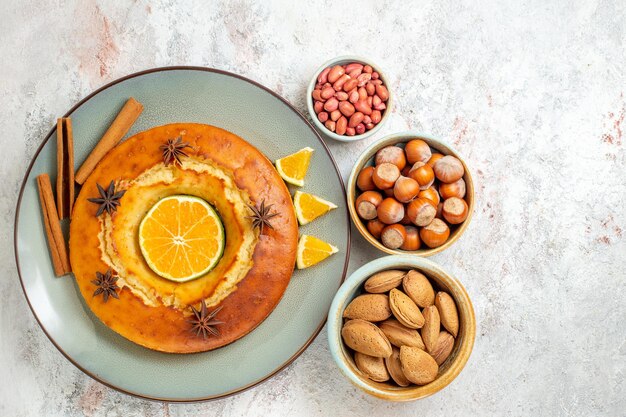 Top view yummy pie delicious dessert for tea with nuts on white background fruit cake pie tea biscuit sweet dessert