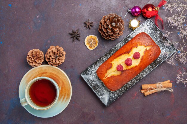 Top view yummy pie long formed with tea on dark surface cake sugar cookie pie sweet biscuit tea