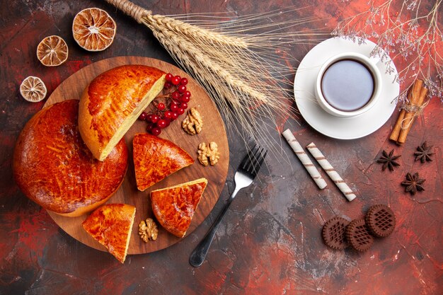 Top view of yummy pies sliced with red berries