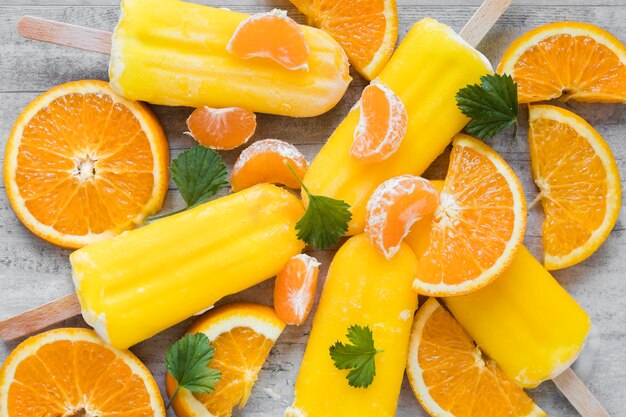 Top view of yummy popsicles with orange and mint