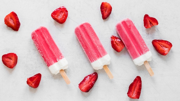 Top view of yummy popsicles with strawberry