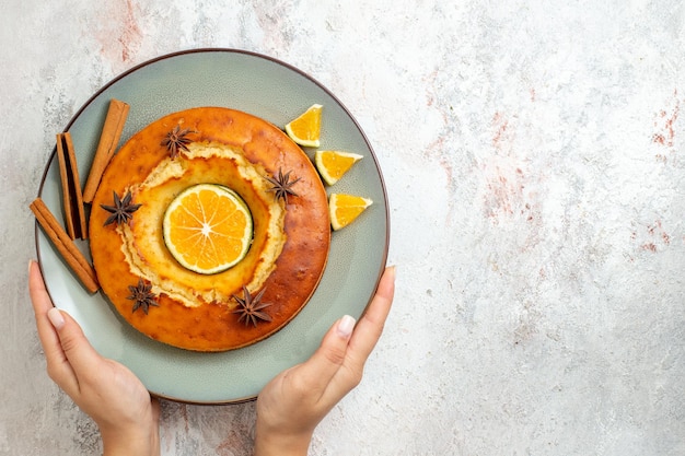 Top view yummy round pie delicious dessert for tea with orange slices on white background fruit cake biscuit tea sweet dessert