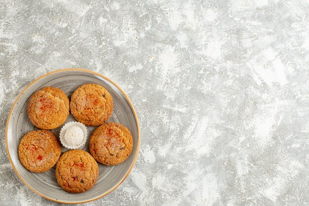 Top view yummy sand cookies inside plate on white background