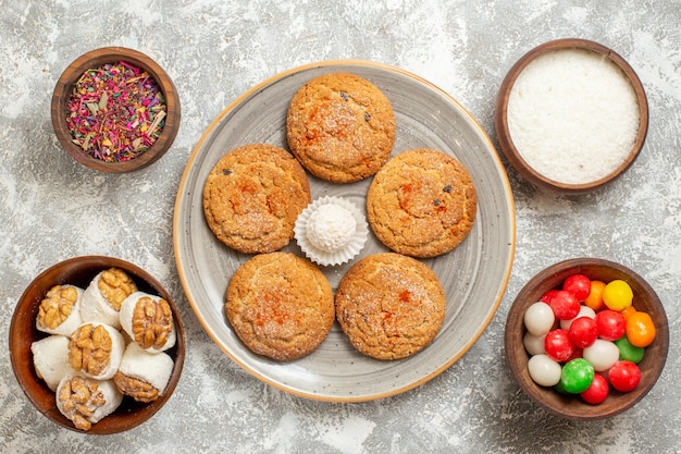 Top view yummy sand cookies with candies on light-white background