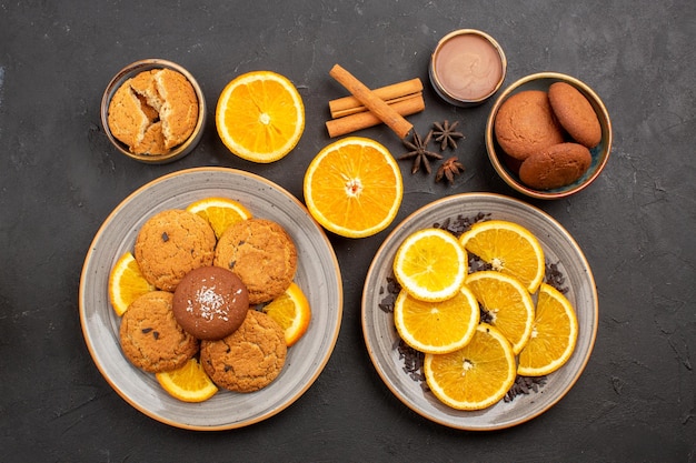 Top view yummy sand cookies with fresh sliced oranges on dark background fruit biscuit sweet cookie sugar citrus color