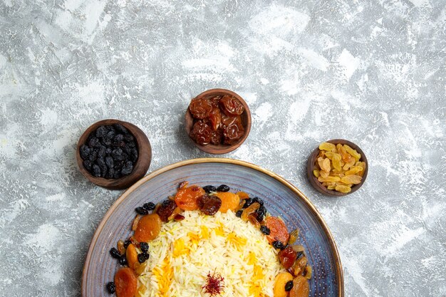 Top view yummy shakh plov cooked rice dish with raisins inside plate on a white