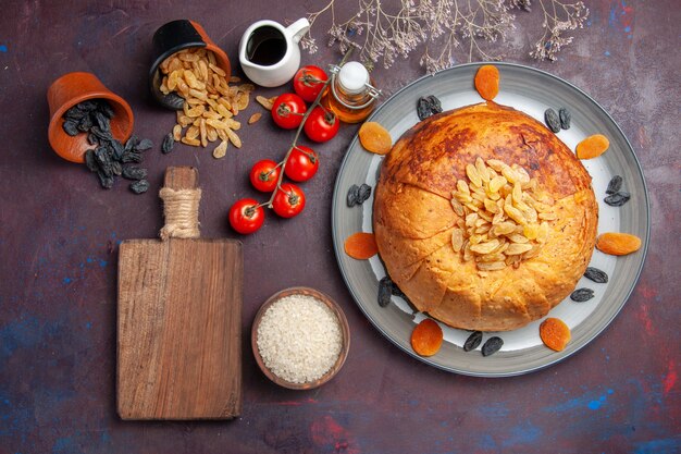 Top view yummy shakh plov cooked rice meal inside dough with tomatoes on dark surface rice meal food dinner cooking