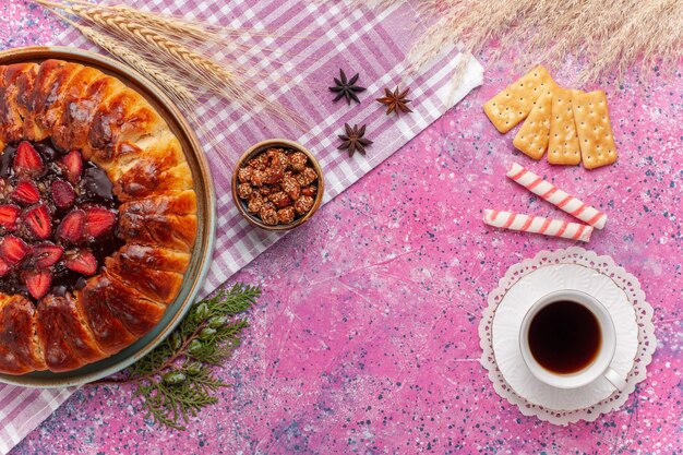 Top view yummy strawberry pie fruity cake on a pink