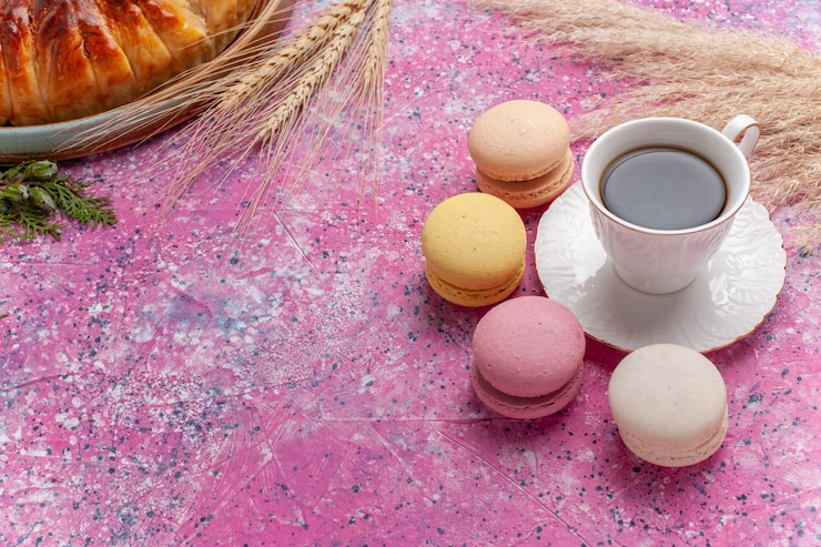 Free Photo top view yummy strawberry pie with cup of tea and macarons on a pink