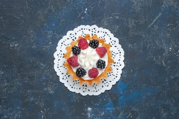 Top view yummy sweet cake with berries and cream on the dark-grey background fruit berry color cake biscuit photo sweet