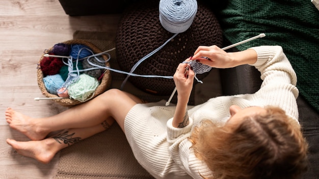 Top woman crocheting on floor