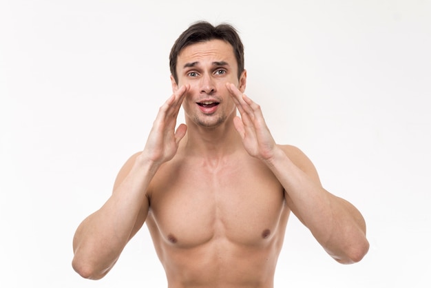 Topless man shouting with white background