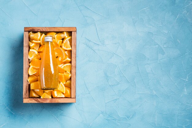 Topview orange juice on blue background copy space