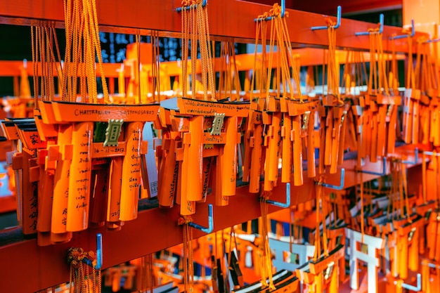 Torii gates model was hanging on rack after tourist used them for make a wish at Fushimi Inari shrine, Kyoto.