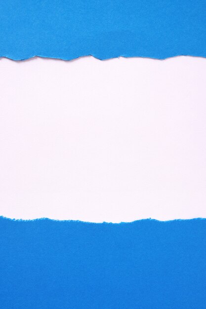 Torn blue paper white background border frame vertical