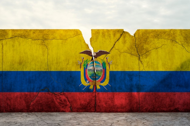 Torn and broken flag of ecuador on cement wall