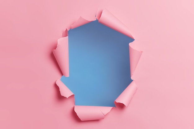 Free photo torn ripped pink background with hole in center for your advertising content or promotion.