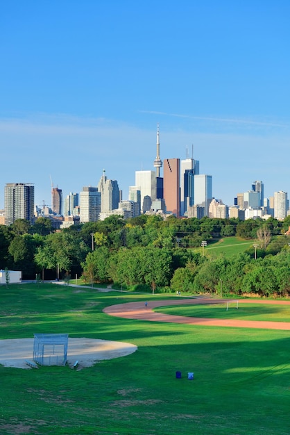 Toronto skyline over park with urban buildings and blue sky