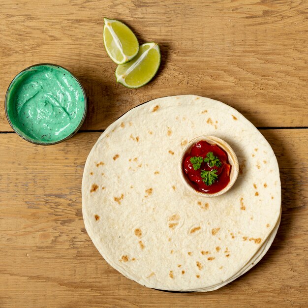 Tortilla with various sauces and sliced lime