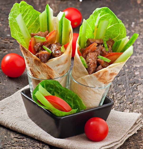 Tortilla wraps with meat and fresh vegetables