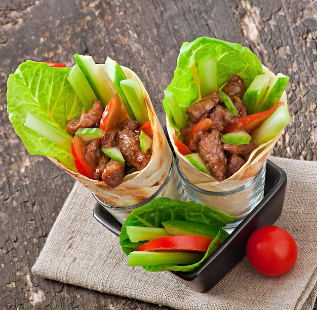 Tortilla wraps with meat and fresh vegetables