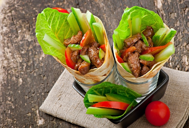 Tortilla wraps with meat and fresh vegetables