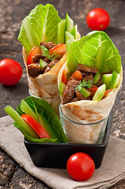 Tortilla wraps with meat and fresh vegetables