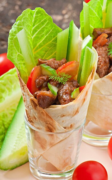 Tortilla wraps with meat and fresh vegetables