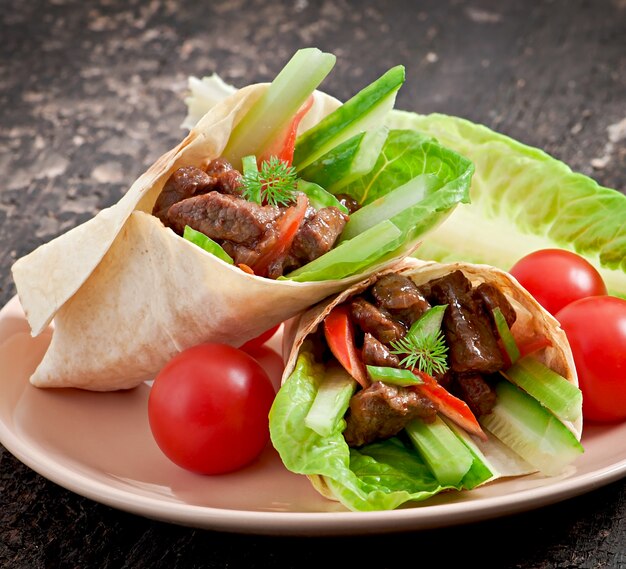 Tortilla wraps with meat and fresh vegetables