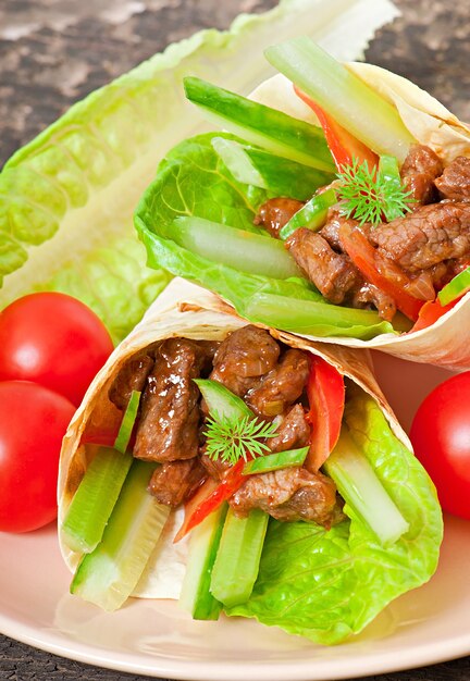 Tortilla wraps with meat and fresh vegetables