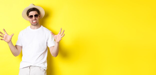 Tourism travelling and holidays concept sassy young man on vacation showing something big and clench