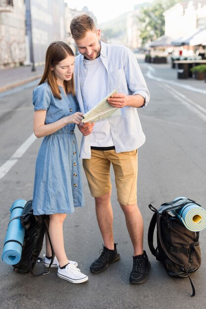 Tourist couple consulting map