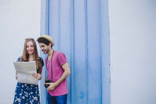 Tourist couple looking at map