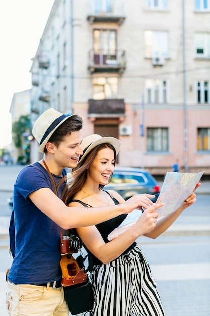 Free Photo tourist couple looking at map