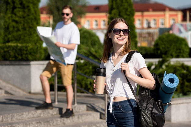 Tourist couple posing outdoors with backpacks