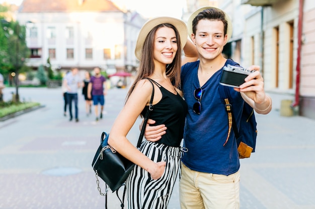 Tourist couple posing for photo in city