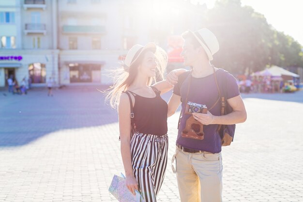 Tourist couple visiting city with sun effect