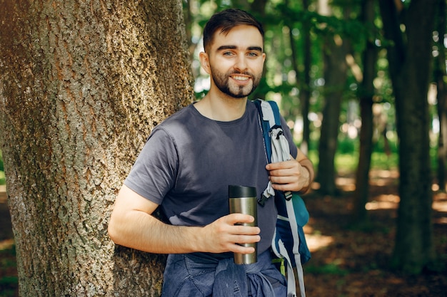 Tourist have a rest in a summer forest