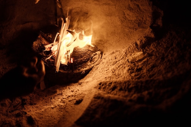 tourist makes a fire on the beach