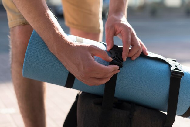 Tourist man getting backpack ready for voyage